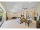 Spacious living room with neutral carpet, and open to the dining area with views to the front entrance at 5508 Whitehead St, Bradenton, FL 34203