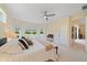 Bright bedroom featuring large windows, a ceiling fan, and neutral decor creating a relaxing retreat at 5508 Whitehead St, Bradenton, FL 34203