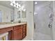 Bathroom features a granite countertop vanity and a glass-enclosed tiled shower at 5528 Palmer Cir # 104, Bradenton, FL 34211