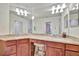 Well-lit bathroom features a double vanity with granite countertops and a large mirror at 5528 Palmer Cir # 104, Bradenton, FL 34211