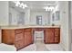 Spacious bathroom with double sinks, granite counters, vanity seating, and tile floors at 5528 Palmer Cir # 104, Bradenton, FL 34211