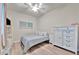 Cozy bedroom with a comfortable bed, crisp white furniture, and a ceiling fan for a restful sleep at 5528 Palmer Cir # 104, Bradenton, FL 34211