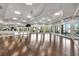 Bright dance studio with mirrors and floor-to-ceiling windows showcasing the outside view at 5528 Palmer Cir # 104, Bradenton, FL 34211
