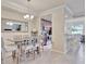 Open-concept dining area leading to a well-equipped kitchen with modern appliances and cozy bar seating at 5528 Palmer Cir # 104, Bradenton, FL 34211