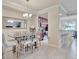 Well-lit dining room complemented by modern lighting fixtures and a view of the adjacent kitchen and breakfast bar at 5528 Palmer Cir # 104, Bradenton, FL 34211