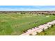 Spacious aerial view of a golf course driving range, complete with parking for golf carts at 5528 Palmer Cir # 104, Bradenton, FL 34211