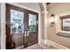 Elegant double-door entryway with decorative lighting and a view of the interior at 5528 Palmer Cir # 104, Bradenton, FL 34211