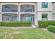Charming two-story home with a screened in lanai and lush green hedge in a well manicured lawn at 5528 Palmer Cir # 104, Bradenton, FL 34211