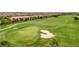 Scenic aerial view of a lush green golf course with a sand trap at 5528 Palmer Cir # 104, Bradenton, FL 34211