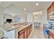 Open-concept kitchen with granite counters, stainless appliances, and eat-in bar at 5528 Palmer Cir # 104, Bradenton, FL 34211