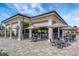 Outdoor dining area with covered seating, tables, umbrellas and bar area at 5528 Palmer Cir # 104, Bradenton, FL 34211