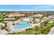 Resort style pool surrounded by lush landscaping, lounge seating, and covered dining areas at 5528 Palmer Cir # 104, Bradenton, FL 34211