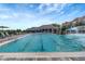 Inviting community pool with lap lanes and a waterfall feature, surrounded by lounge chairs at 5528 Palmer Cir # 104, Bradenton, FL 34211