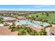 Resort style pool with lush tropical landscaping, waterfall feature, and surrounding golf course at 5528 Palmer Cir # 104, Bradenton, FL 34211