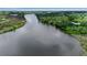 Gorgeous aerial perspective showing the wide river flowing beside the green landscape at 5935 River Forest Cir, Bradenton, FL 34203