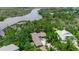 Beautiful aerial view of a single-Gathering home surrounded by lush trees, overlooking a scenic river at 5935 River Forest Cir, Bradenton, FL 34203
