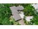 Expansive aerial view of a single-story home with a large yard surrounded by lush greenery at 5935 River Forest Cir, Bradenton, FL 34203