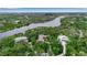 Scenic aerial view showcasing a beautiful home surrounded by lush greenery and a winding river nearby at 5935 River Forest Cir, Bradenton, FL 34203