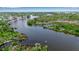 Picturesque aerial view with the river winding past the property and lush shoreline at 5935 River Forest Cir, Bradenton, FL 34203