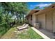 Backyard with a grassy lawn and two lounge chairs at 5935 River Forest Cir, Bradenton, FL 34203