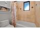 Compact bathroom with a tiled shower, shower curtain, and coordinating storage cabinet for added convenience at 5935 River Forest Cir, Bradenton, FL 34203