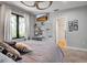 Cozy bedroom with a ceiling fan, a stylish desk area, and a glimpse into an adjacent tiled space at 5935 River Forest Cir, Bradenton, FL 34203