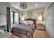 Cozy bedroom with a muted color scheme, a ceiling fan, mirrored side tables, and plush carpeting at 5935 River Forest Cir, Bradenton, FL 34203