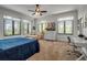 Bedroom with large windows and a ceiling fan at 5935 River Forest Cir, Bradenton, FL 34203