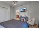 Bedroom with a hanging chair, vanity, and TV at 5935 River Forest Cir, Bradenton, FL 34203