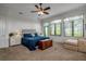 Bedroom with large windows, a ceiling fan and a chest at 5935 River Forest Cir, Bradenton, FL 34203