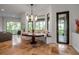 Dining area with custom bench seating, modern lighting and an adjacent outdoor patio at 5935 River Forest Cir, Bradenton, FL 34203