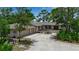 Attractive single-story home with a two-car garage, complemented by a well-maintained yard and mature trees at 5935 River Forest Cir, Bradenton, FL 34203