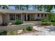 The home's attractive front exterior showcases a low brick fence and manicured greenery at 5935 River Forest Cir, Bradenton, FL 34203