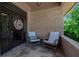 Cozy front porch featuring stone tile, a decorative wreath, and comfortable seating at 5935 River Forest Cir, Bradenton, FL 34203