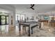 Game room with a pool table that connects to the dining and living areas at 5935 River Forest Cir, Bradenton, FL 34203