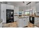 Bright kitchen featuring white cabinets, granite counters, and stainless steel appliances at 5935 River Forest Cir, Bradenton, FL 34203