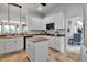 Bright kitchen featuring granite countertops, white cabinets and a center island at 5935 River Forest Cir, Bradenton, FL 34203