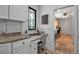 Kitchen featuring granite countertops, white cabinets and a corner desk space at 5935 River Forest Cir, Bradenton, FL 34203
