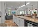 Bright kitchen showcasing granite counters, white cabinets, and an open layout connected to the living room at 5935 River Forest Cir, Bradenton, FL 34203