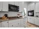 Modern kitchen featuring white cabinets, granite countertops, subway tile backsplash and stainless steel appliances at 5935 River Forest Cir, Bradenton, FL 34203