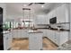 Spacious kitchen featuring a center island, granite countertops and stainless steel appliances at 5935 River Forest Cir, Bradenton, FL 34203