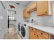 Laundry room featuring a washer and dryer, with built in cabinets and stone flooring at 5935 River Forest Cir, Bradenton, FL 34203