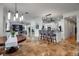 Open-concept living space with travertine floors, modern lighting, kitchen and seating area at 5935 River Forest Cir, Bradenton, FL 34203