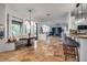 Open-concept living space with travertine floors, barstool seating and comfortable seating at 5935 River Forest Cir, Bradenton, FL 34203