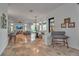 Open-concept living space with travertine floors, comfortable seating, and natural light at 5935 River Forest Cir, Bradenton, FL 34203