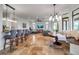 Open-concept living space with travertine floors, barstool seating and comfortable seating at 5935 River Forest Cir, Bradenton, FL 34203