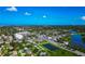 Wide aerial view of a neighborhood featuring a lush landscape and blue skies at 5948 Mirror Lake Rd, Sarasota, FL 34238