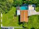 Aerial view of backyard with mature trees surrounding the screened pool and fenced in yard at 5948 Mirror Lake Rd, Sarasota, FL 34238