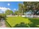 Large backyard with grass, storage shed, car port, and privacy fence at 5948 Mirror Lake Rd, Sarasota, FL 34238