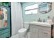 Stylish bathroom featuring a vanity sink, toilet, and custom-colored cabinet at 5948 Mirror Lake Rd, Sarasota, FL 34238